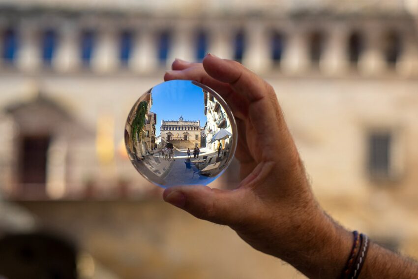 person holding clear glass ball