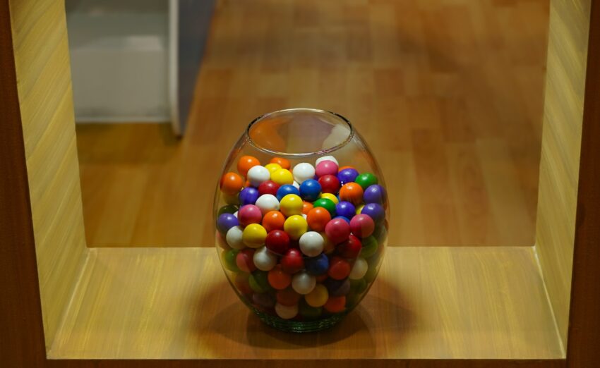 a glass vase filled with lots of colorful balls